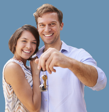 Young happy couple holding keys for their new house